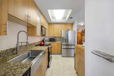 a kitchen with refrigerator and cabinets