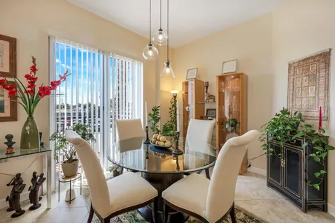 a view of a dining room with furniture window and flowerpot