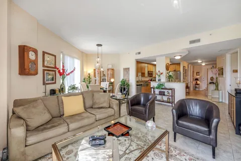 a living room with furniture kitchen view and a table