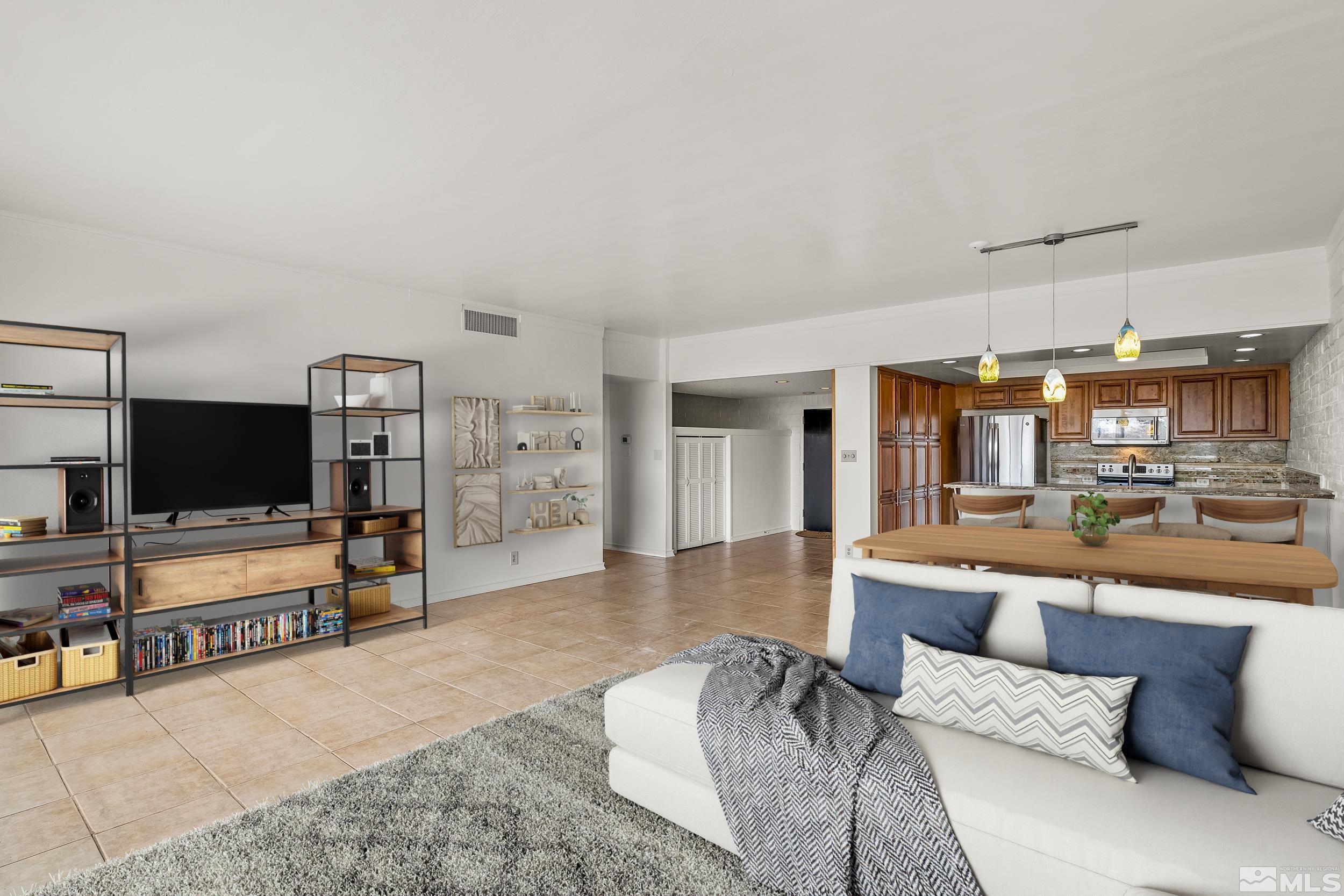 1200 Riverside Drive, Unit #1209 Reno, NV 89503 - Photo 9 of 35 a living room with furniture and a flat screen tv