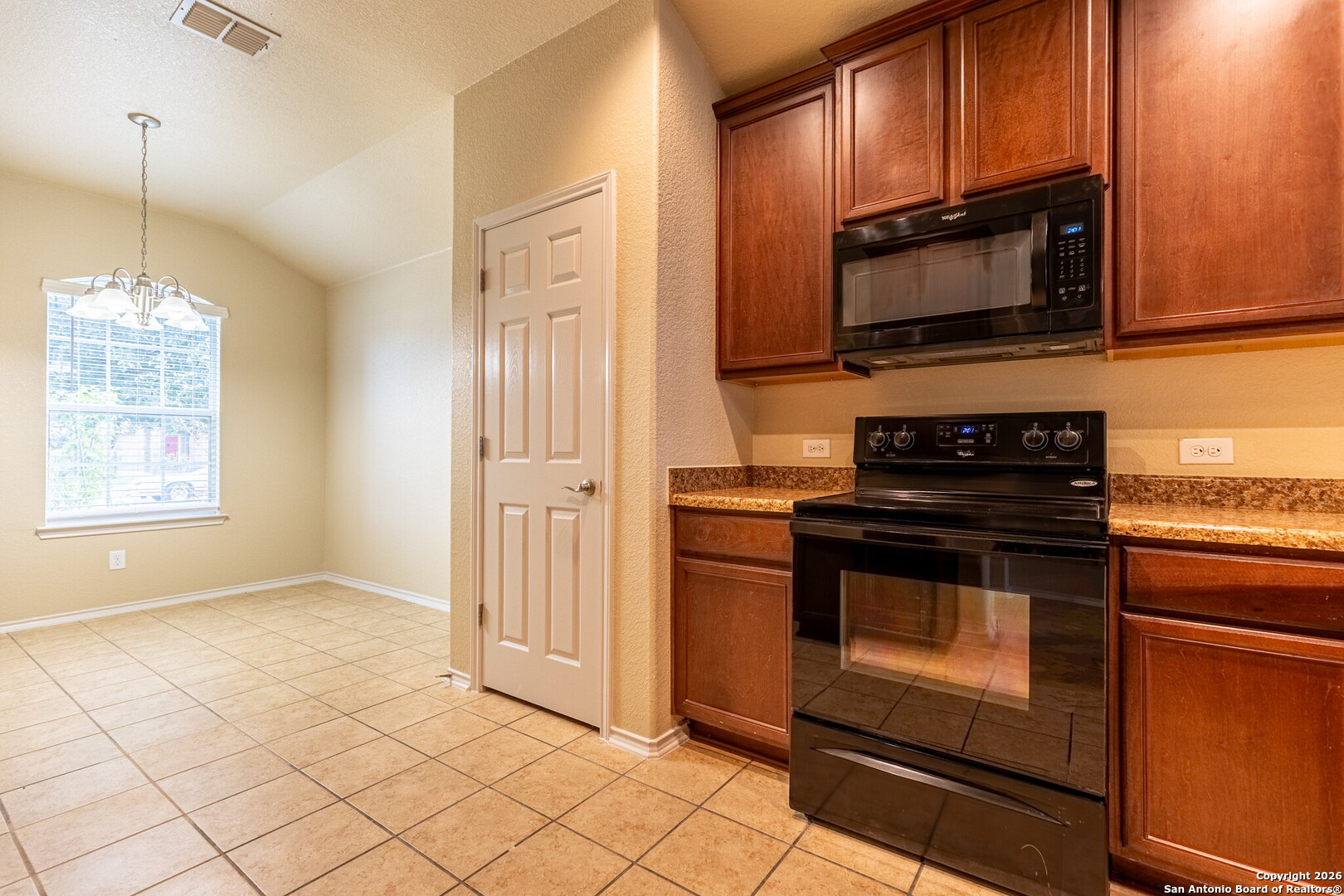 3815 Bogie Way Converse, TX 78109 - Photo 11 of 32 a kitchen with stainless steel appliances granite countertop a stove a microwave and a sink
