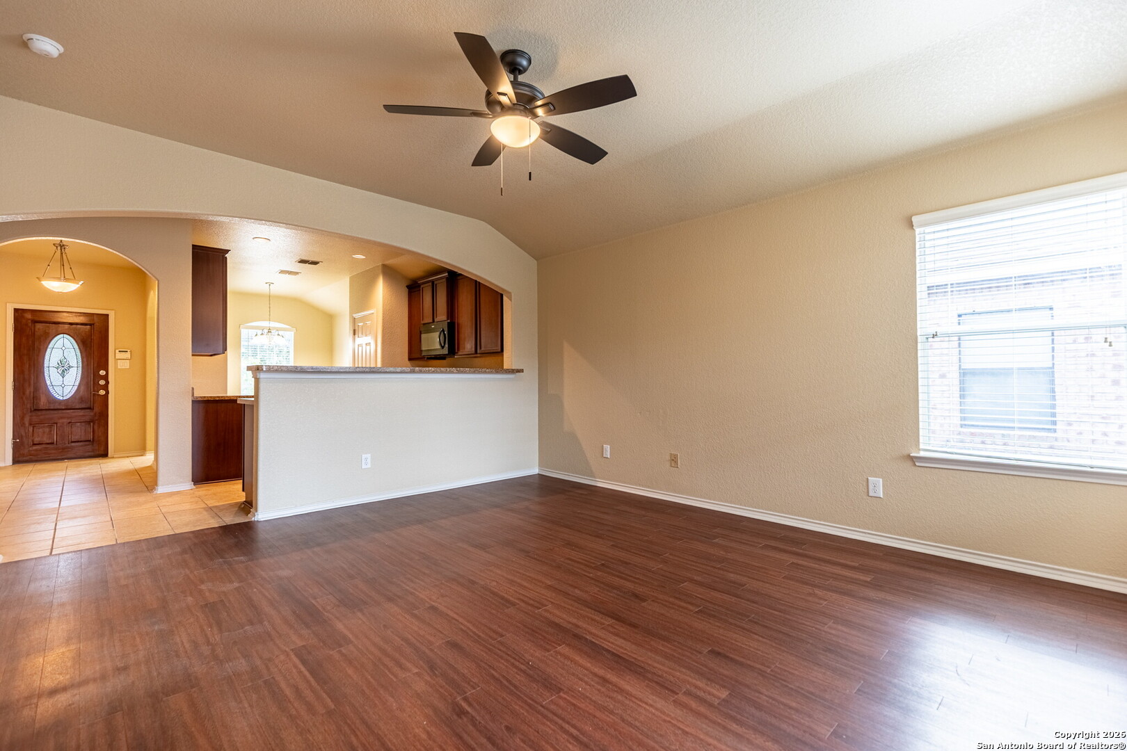 3815 Bogie Way Converse, TX 78109 - Photo 14 of 32 an empty room with wooden floor fan and windows
