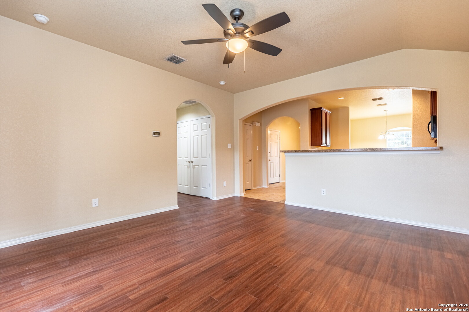 3815 Bogie Way Converse, TX 78109 - Photo 15 of 32 an empty room with wooden floor and a ceiling fan