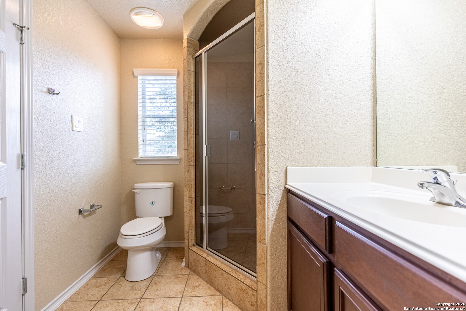 3815 Bogie Way Converse, TX 78109 - Photo 25 of 32 a bathroom with a granite countertop sink a toilet and shower