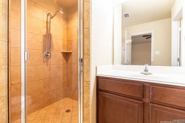 a bathroom with a shower and a sink