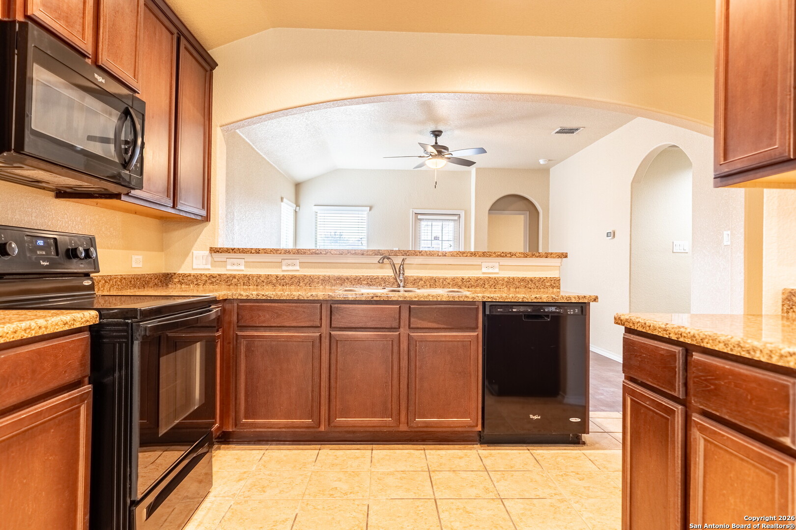 3815 Bogie Way Converse, TX 78109 - Photo 7 of 32 a view of a kitchen with granite countertop cabinets and a stove top oven