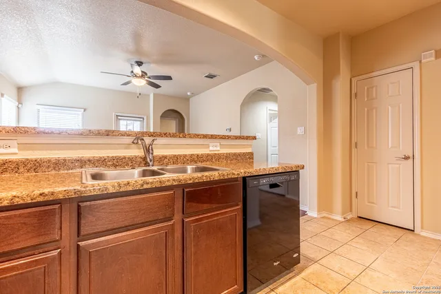 a view of a kitchen with a sink and a window