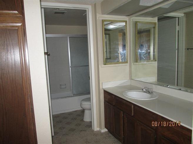 1050 Ramon Road, Unit 80 Palm Springs, CA 92264 - Photo 4 of 10 a bathroom with a granite countertop sink toilet and shower