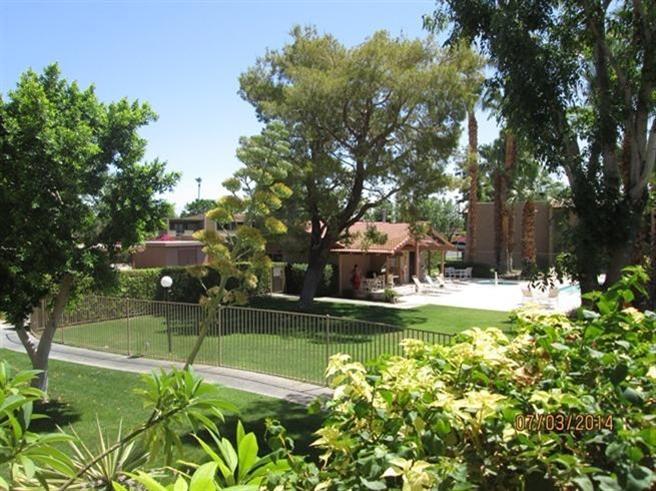 1050 Ramon Road, Unit 80 Palm Springs, CA 92264 - Photo 7 of 10 a view of a house with a big yard and large trees