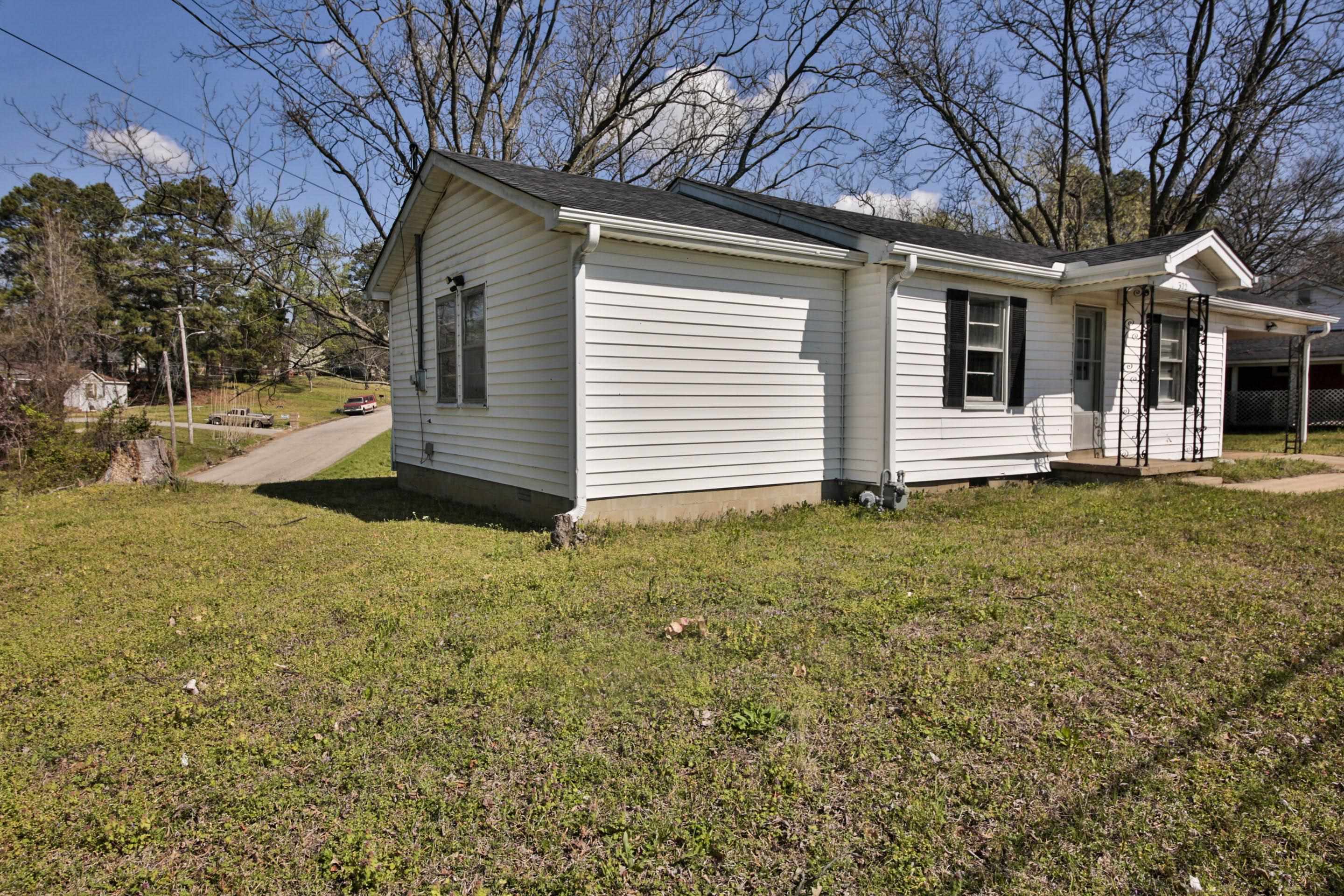 322 Highland Street Ripley, TN 38063 - Photo 3 of 12 View of home's exterior featuring a lawn and crawl space