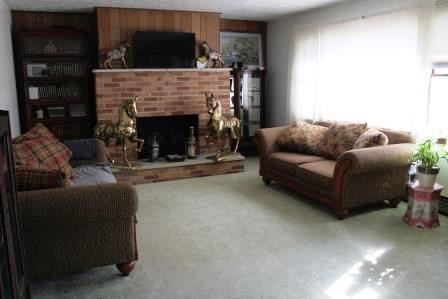 16544 Tionesta Road Pleasantville, PA 16341 - Photo 13 of 32 a living room with furniture a flat screen tv and a fireplace