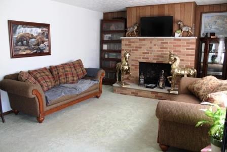 16544 Tionesta Road Pleasantville, PA 16341 - Photo 19 of 32 a living room with furniture a flat screen tv and a fireplace