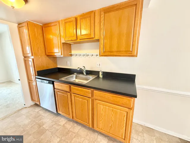a kitchen with granite countertop a sink and a window