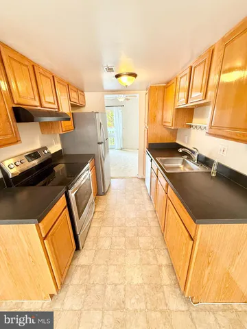 a kitchen that has a sink and a stove