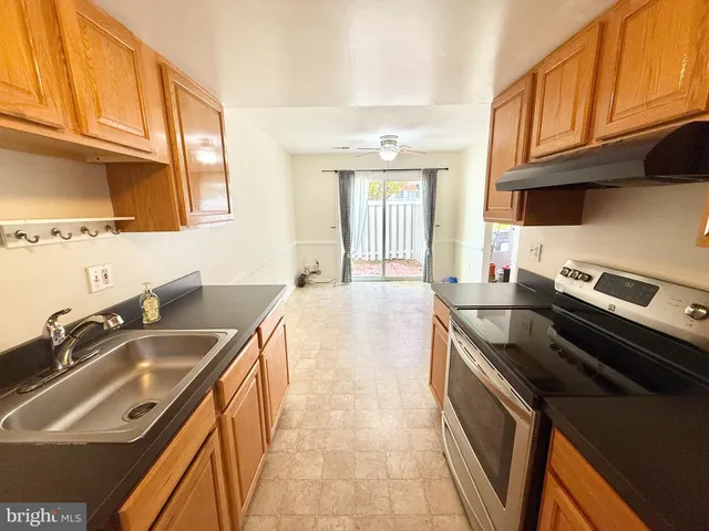 a kitchen that has a sink and a stove
