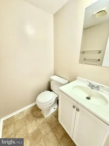 a white toilet sitting next to a bathroom sink