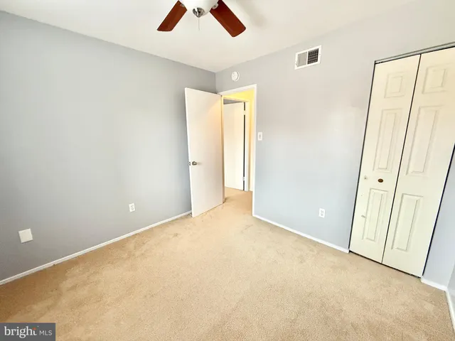 an empty room with fan and window