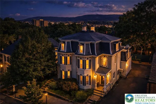 a front view of a residential apartment building with a yard