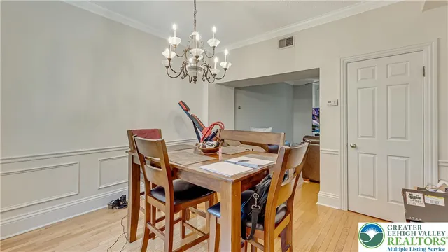 a view of a dining room with furniture and chandelier