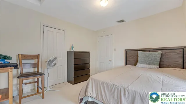 a bedroom with a bed and a chair