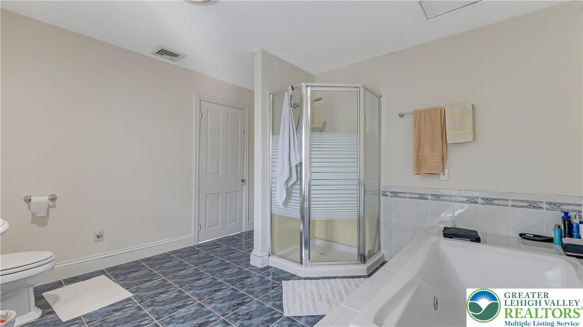 205 West Broad Street Bethlehem, PA 18018 - Photo 32 of 40 a bathroom with a granite countertop sink a toilet and shower