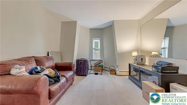 a living room with furniture and a dresser