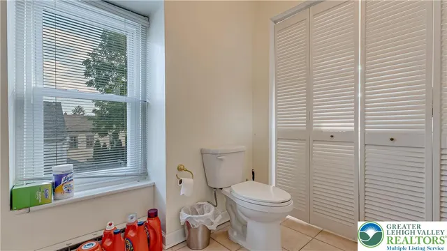 a bathroom with a toilet and a shower curtain
