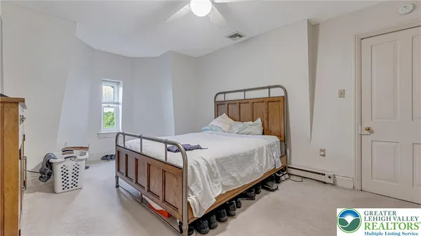 a bedroom with a bed and a window