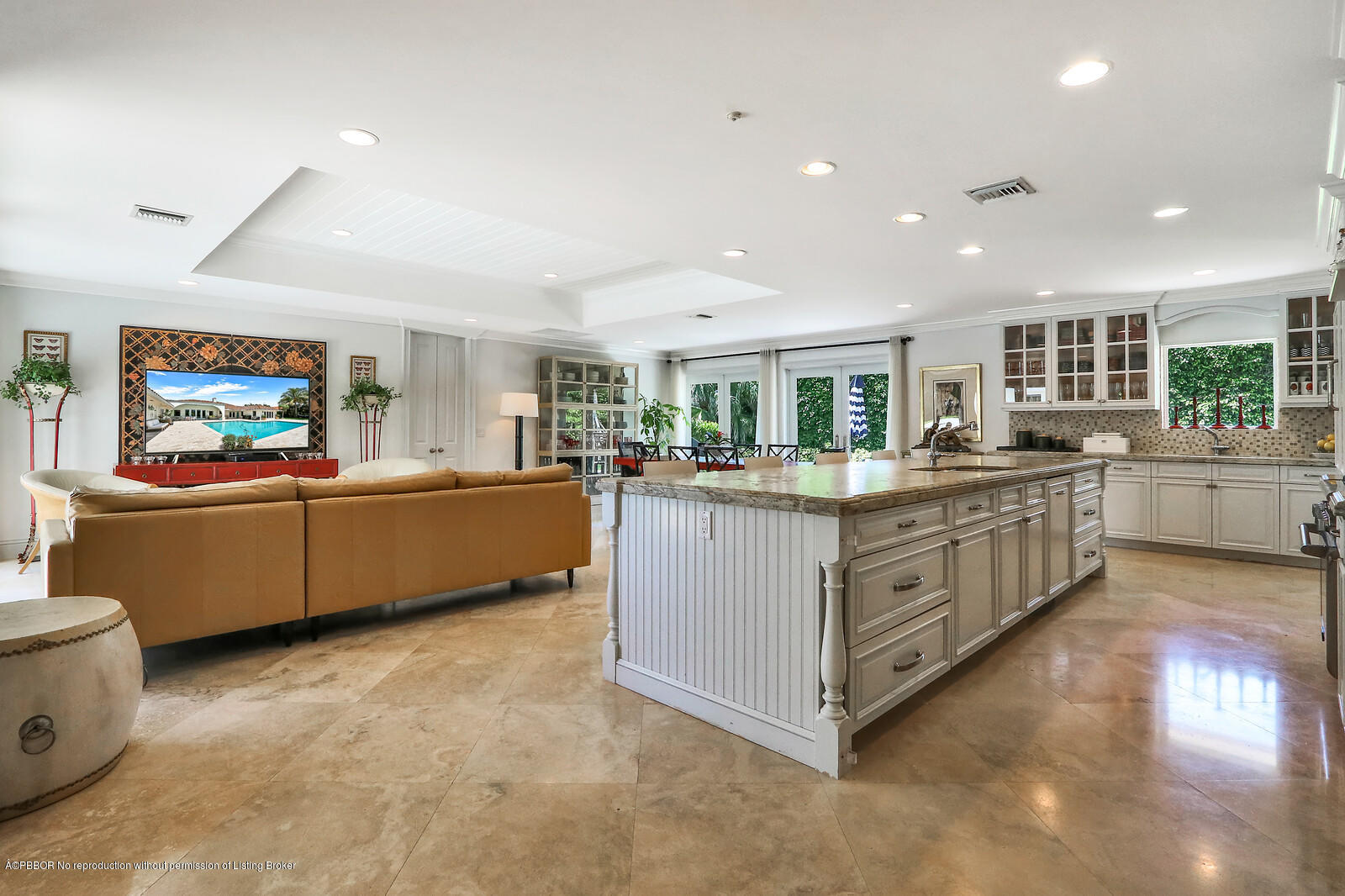 95 Spoonbill Road Manalapan, FL 33462 - Photo 13 of 32 a kitchen with stainless steel appliances kitchen island a large counter top a sink a stove and a refrigerator