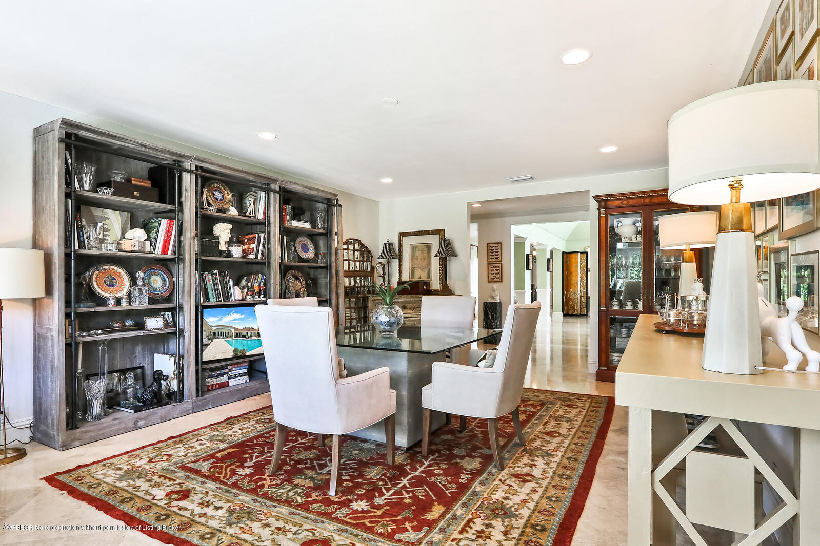 95 Spoonbill Road Manalapan, FL 33462 - Photo 16 of 32 a dining room with wooden floor and a book shelf