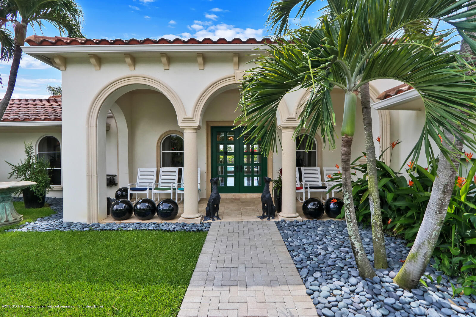 95 Spoonbill Road Manalapan, FL 33462 - Photo 3 of 32 a front view of a house with garden