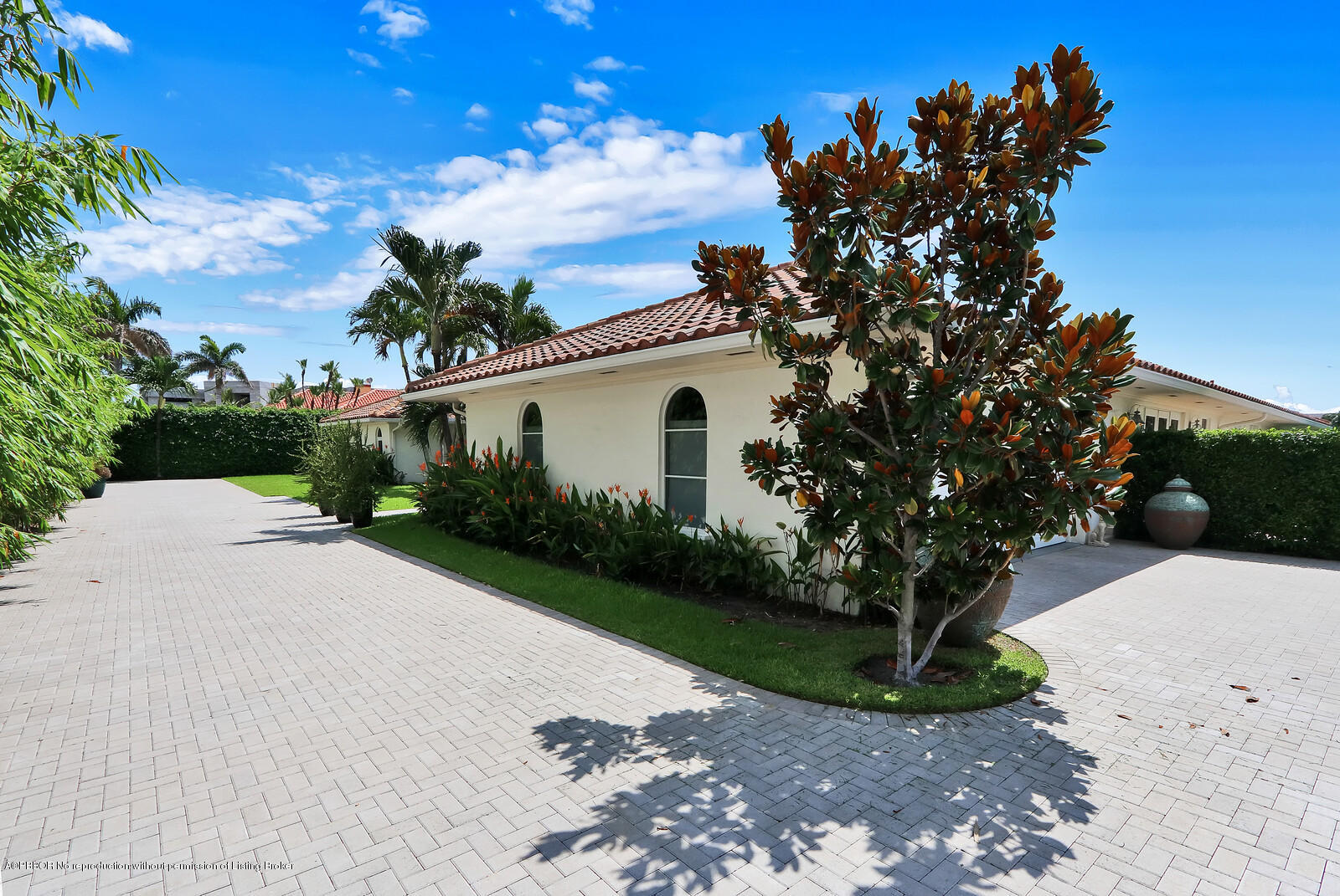 95 Spoonbill Road Manalapan, FL 33462 - Photo 22 of 32 a white house with a flower garden in front of it