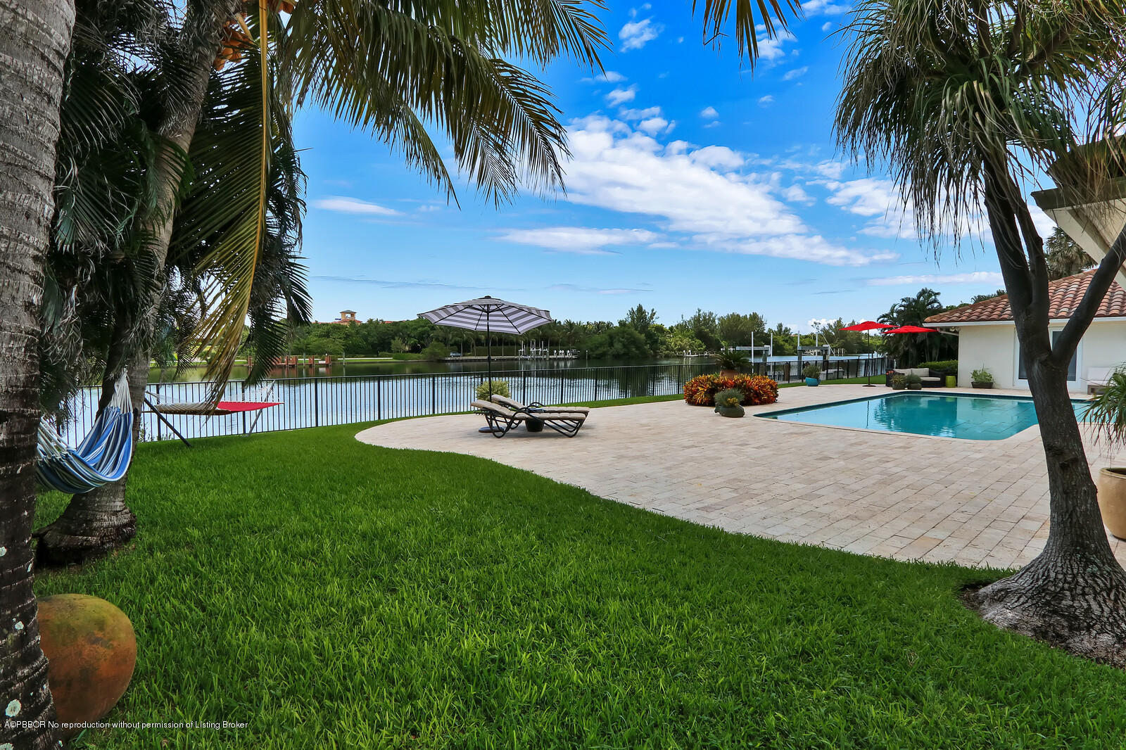 95 Spoonbill Road Manalapan, FL 33462 - Photo 23 of 32 a view of a garden and swimming pool