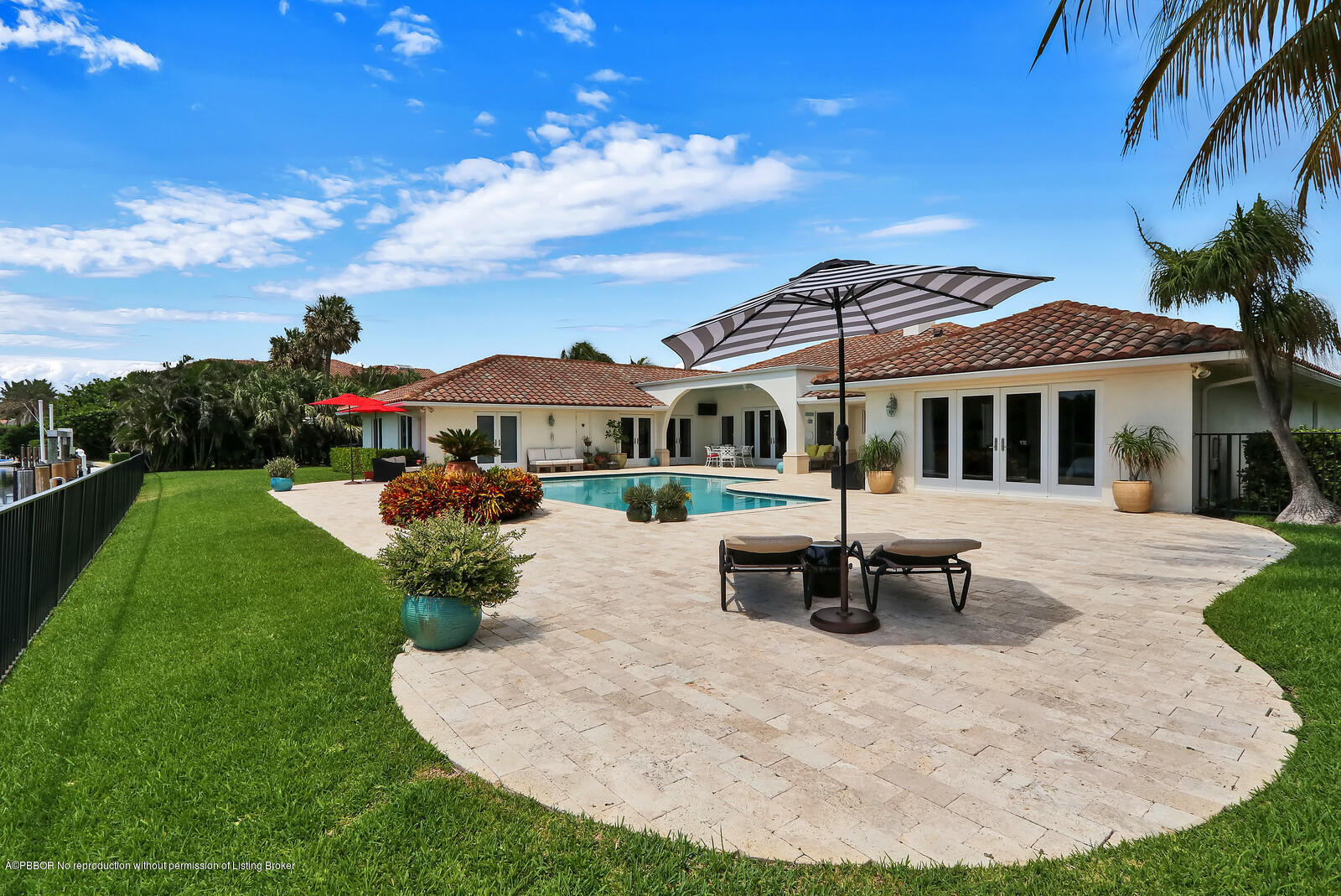 95 Spoonbill Road Manalapan, FL 33462 - Photo 24 of 32 a view of a house with backyard porch and sitting area