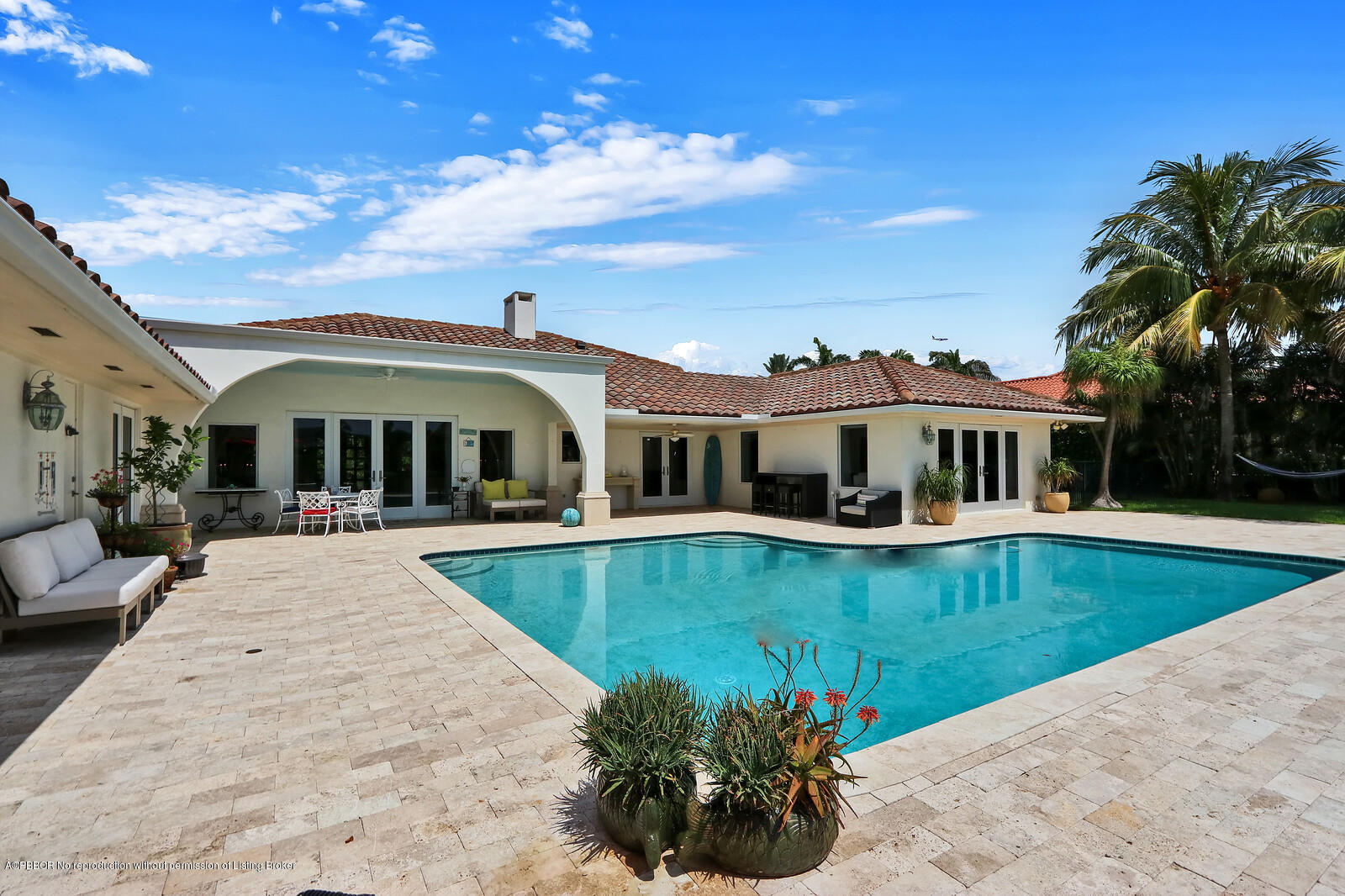 95 Spoonbill Road Manalapan, FL 33462 - Photo 27 of 32 a front view of house with swimming pool and yard