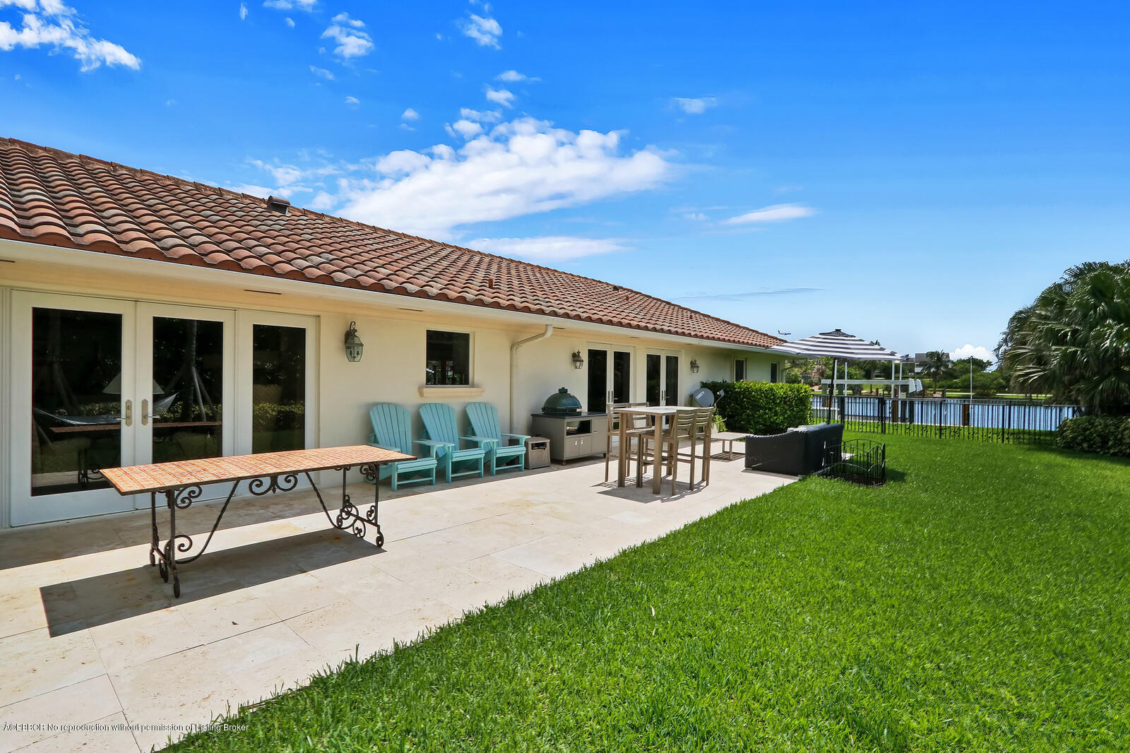 95 Spoonbill Road Manalapan, FL 33462 - Photo 30 of 32 a view of a house with patio and garden