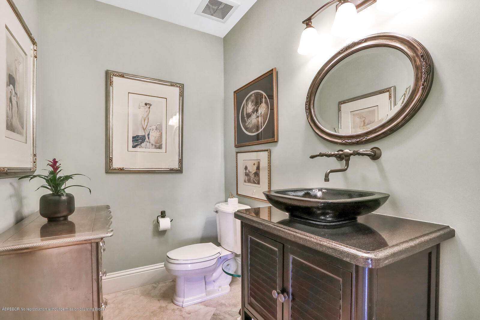 95 Spoonbill Road Manalapan, FL 33462 - Photo 9 of 32 a bathroom with a toilet a sink and a mirror