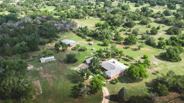 an aerial view of residential houses with outdoor space