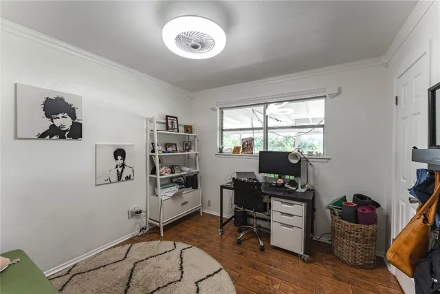 a view of a workspace with furniture and a window