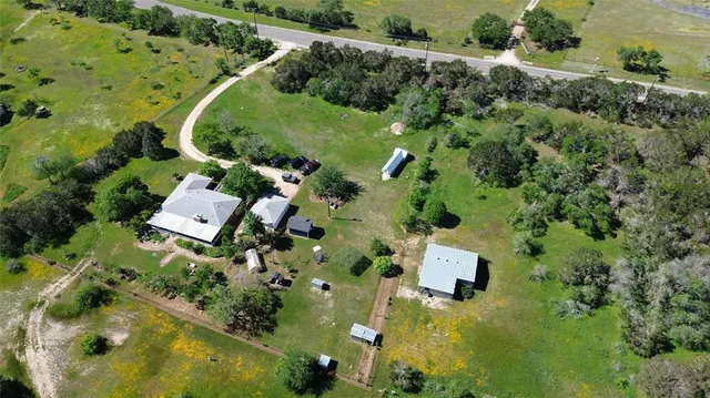 an aerial view of residential house with outdoor space and swimming pool