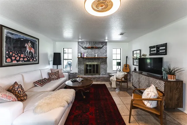 a living room with furniture a flat screen tv and a fireplace