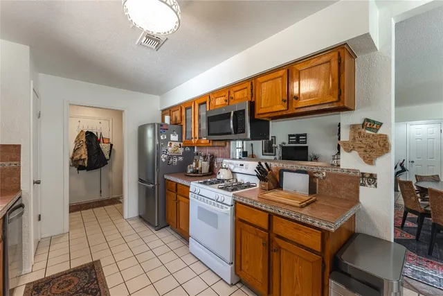 a kitchen with a stove and a refrigerator