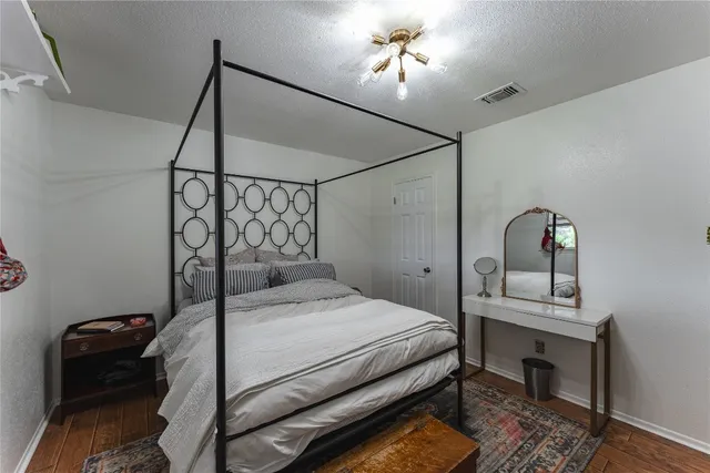 a bedroom with a bed and a desk