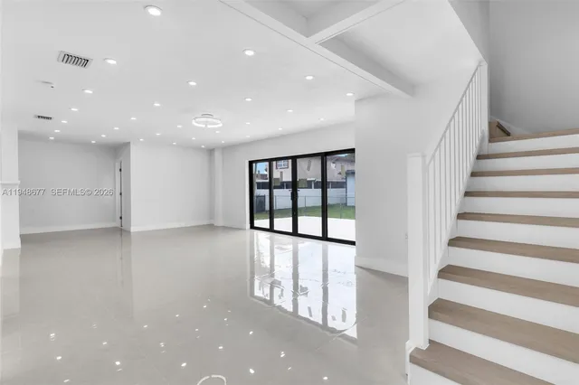 a view of staircase with white walls and windows