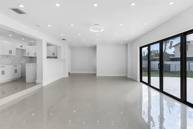 a view of a kitchen with large windows