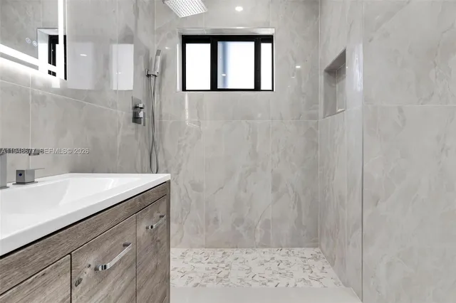 a bathroom with a sink a vanity and a mirror