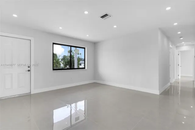 an empty room with windows and closet