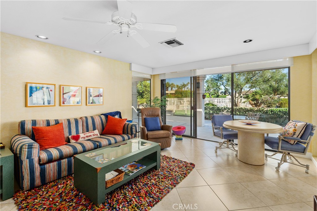 5 Princeton Drive Rancho Mirage, CA 92270 - Photo 11 of 27 a living room with furniture a rug and a large window