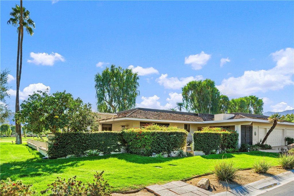 5 Princeton Drive Rancho Mirage, CA 92270 - Photo 19 of 27 a front view of a house with garden