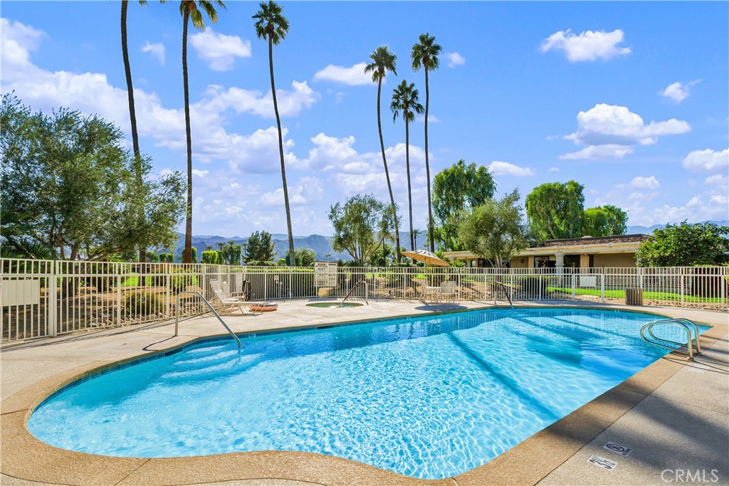 5 Princeton Drive Rancho Mirage, CA 92270 - Photo 4 of 27 a view of a swimming pool with a lounge chairs